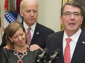 Secretary of defence Ashton Carter, right, speaks beside his wife, Stephanie, and then U.S. vice-president Joe Biden during a ceremony at the White House on Feb. 17, 2015. Stephanie Carter says Biden placed his hands on her shoulders as a gesture of support between friends. Other women however, have accused the former vice-president of inappropriate touching.