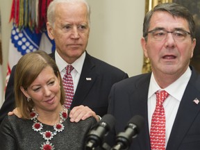 In this file photo taken on February 17, 2015,  Secretary of Defense Ashton Carter (R) speaks beside his wife Stephanie and US Vice President Joe Biden during a swearing-in ceremony in the Roosevelt Room of the White House in Washington, DC.