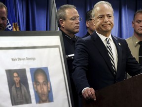 United States Attorney Nick Hanna stands next to photos of Mark Steven Domingo, during a news conference in Los Angeles on April 29, 2019.