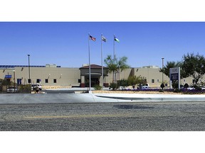 FILE - This May 19, 2015 file photo shows the Adelanto Detention Center in Adelanto, Calif., a desert community northeast of Los Angeles. For nearly eight years, Adelanto has joined with a private prison company and federal officials to run California's largest immigration detention facility. Now, the city of Adelanto is backing out of its contract to run the 1,900 bed facility amid complaints of shoddy conditions and inadequate medical care. But ending the deal won't necessarily shutter the center and rather, could pave the way for its expansion.