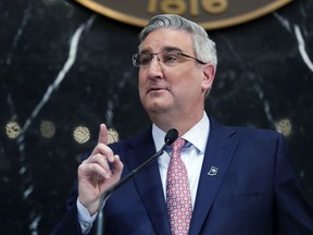 FILE - In this Jan. 15, 2019 file photo, Indiana Gov. Eric Holcomb delivers his State of the State address to a joint session of the legislature at the Statehouse in Indianapolis. Holcomb on Wednesday, April 3, 2019 signed legislation aimed at getting Indiana off a list of five states without a hate crimes law. The other states without such laws are Georgia, South Carolina, Wyoming and Arkansas.