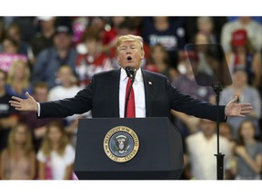FILE - In this June 20, 2018 file photo, U.S. President Donald Trump speaks at a campaign rally in Duluth, Minn. Trump heads back to Minnesota on the nation's tax filing deadline, Monday, April 15, 2019, eager to remind voters in a state he nearly carried in 2016 about the $1.5 trillion Republican tax cut. It's a policy achievement that won't resonate with everyone in Minnesota, where the loss of the state tax deduction hurt some taxpayers. And national polls show most Americans don't have a clear idea what the tax cuts did for them.
