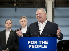 Ontario Premier Doug Ford gives remarks at a car dealership alongside MPP Jeff Yurek and provincial Environment Minister Rod Phillips, in Toronto, on Monday, April 1, 2019.