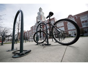 A lone bicycle stands in the rack outside East High School, Wednesday, April 17, 2019, in Denver. Denver-area public schools closed Wednesday as the FBI hunted for an armed young Florida woman who was allegedly "infatuated" with Columbine and threatened violence just days ahead of the 20th anniversary of the attack.