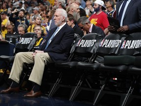 San Antonio Spurs head coach Gregg Popovich sits on the bench before facing the Denver Nuggets in Game 7 of an NBA basketball first-round playoff series Saturday, April 27, 2019, in Denver.