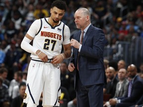 Denver Nuggets head coach Michael Malone, right, confers with guard Jamal Murray during a break in the action against the Portland Trail Blazers in the first half of Game 1 of an NBA basketball second-round playoff series Monday, April 29, 2019, in Denver.