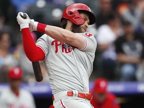 Philadelphia Phillies' Bryce Harper strikes out against Colorado Rockies starting pitcher Jon Gray in the fourth inning of a baseball game Sunday, April 21, 2019, in Denver.