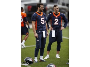 Denver Broncos quarterbacks Joe Flacco, left, and Garrett Grayson take part in drills during an NFL football veterans minicamp at the team's headquarters Tuesday, April 16, 2019, in Englewood, Colo.