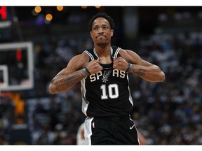 San Antonio Spurs guard DeMar DeRozan rips his jersey as he heads to the bench after drawing his second personal foul against the Denver Nuggets early in the first half of Game 2 of an NBA basketball playoff series Tuesday, April 16, 2019, in Denver.