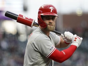 Philadelphia Phillies' Bryce Harper warms up in the on-deck circle during the first inning of the team's baseball game against the Colorado Rockies on Thursday, April 18, 2019, in Denver.