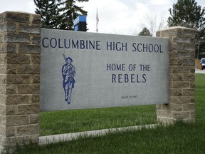 A patrol car is parked in front of Columbine High School, Wednesday, April 17, 2019, in Littleton, Colo., where two student killed 12 classmates and a teacher in 1999. The school was closed along with hundreds of others in Colorado after an armed young Florida woman who was allegedly "infatuated" with Columbine threatened violence just days ahead of the 20th anniversary of the attack.