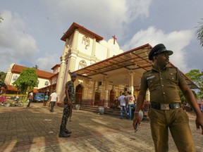 Sri Lankan army soldiers secure the area around St. Sebastian's Church damaged in blast in Negombo, north of Colombo, Sri Lanka, Sunday, April 21, 2019.  More than hundred were killed and hundreds more hospitalized with injuries from eight blasts that rocked churches and hotels in and just outside of Sri Lanka's capital on Easter Sunday, officials said, the worst violence to hit the South Asian country since its civil war ended a decade ago.