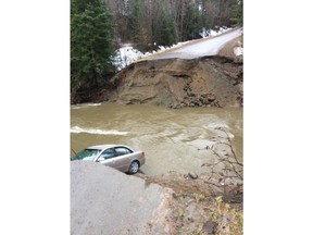 A vehicle is seen in a gaping hole in the road in the Municipality of Pontiac, about 30 km northwest of Ottawa in this photo posted on the Twitter page of MRC des Collines-de-l'Outaouais. One person has died amid flooding in western Quebec, after rising river levels swept away part of a road in the Outaouais region overnight. Police confirmed the death in a tweet Saturday morning, posting a photo of a gaping hole along the road in the Municipality of Pontiac, about 30 km northwest of Ottawa.