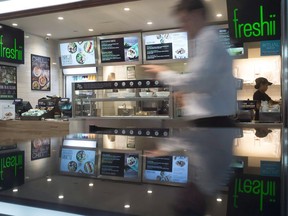 A man walks by a Freshii restaurant in Toronto on Tuesday, March 21, 2017. Freshii Inc. says its chief financial officer will leave the company early next month. The eatery says Craig De Pratto informed the company he will resign to pursue another opportunity.
