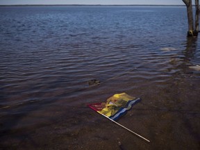 A New Brunswick flag floats in floodwater from the St. John River in Waterborough, N.B., on May 13, 2018. Residents who live near the banks of the St. John River in New Brunswick are being told to brace for significant flooding over the Easter weekend.THE CANADIAN PRESS/Darren Calabrese