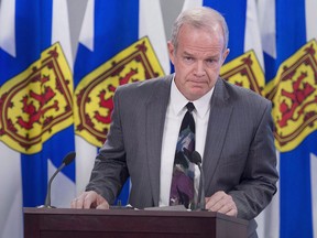 Justice Minister Mark Furey listens to a question at press conference in Halifax on April 3, 2018. Nova Scotia is getting $4.7-million over five years in federal funding to help address crime, including gun and gang violence and a growing human trafficking problem. The money will go toward developing a gun and gang violence strategy, improved intelligence gathering, and enhanced training for police officers and Crown attorneys.