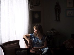 Teva Harrison poses at her home in Toronto on Monday, April 25, 2016. Online tributes are pouring in for Teva Harrison, a Toronto artist and author who touched readers with her poignant depictions of her journey with metastatic breast cancer in the acclaimed graphic memoir, "In-Between Days." Her husband, David Leonard, tweeted that Harrison had died peacefully in her sleep over the weekend after suffering complications earlier this month.