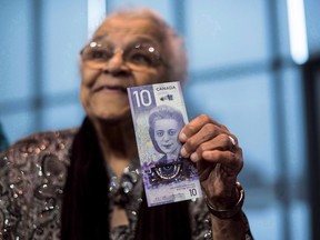 Wanda Robson, sister of Viola Desmond, holds the new $10 bank note featuring Desmond during a press conference in Halifax on Thursday, March 8, 2018. Canada's new $10 bill featuring Nova Scotia human rights icon Viola Desmond has been named bank note of the year.The bill, which also shows a map of Halifax's north end and the Canadian Museum for Human Rights in Winnipeg, was honoured in a vote by the International Bank Note Society.