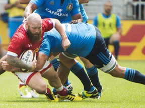 Canada's Ray Barkwill, left, is tackled by Italy's Marco Fuser, right, during first half summer series rugby action in Toronto on Sunday, June 26, 2016. Veteran Canada hooker Ray Barkwill, who had hoped to make a second Rugby World Cup appearance this fall at age 39, has announced his retirement due to medical reasons.
