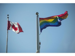 A rainbow flag flies at Queen's Park at the annual Pride flag raising ceremony at the official launch of Pride Month in Toronto on Wednesday, June 1, 2016. A new commemorative loonie set to be unveiled next week is sparking concern among academics and advocates who fear it could perpetuate myths about the history between Canada and lesbian, gay, trans, queer and two spirited persons.