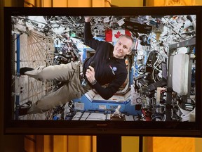 Canadian Space Agency astronaut David Saint-Jacques is seen on a live monitor from the International Space Station during a video conference with Prime Minister Justin Trudeau and Governor General Julie Payette and a group of students at Rideau Hall in Ottawa on Monday, Jan. 14, 2019.