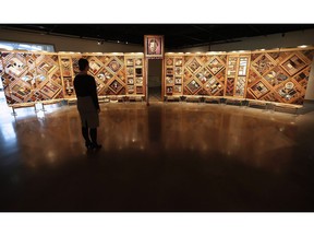 Visitors to the Canadian Museum for Human Rights in Winnipeg can view a new exhibit called The Witness Blanket Monday, December 14, 2015. The Canadian Museum for Human Rights and First Nations artist Carey Newman are signing an agreement regarding the protection and use of "The Witness Blanket." The 12-metre-long, cedar-framed installation is comprised of more than 800 items collected from the sites and survivors of residential schools assembled in the style of a woven blanket.