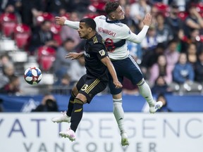 Vancouver Whitecaps defender Jake Nerwinski (28) heads the ball with Los Angeles FC defender Mohamed El-Munir (13) during the second half of MLS soccer action in Vancouver, B.C. Wednesday, April 17, 2019. The Vancouver Whitecaps finally have a win in the books but there was little time for celebration this week.