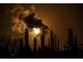 A flare stack lights the sky from the Imperial Oil refinery in Edmonton on December 28, 2018. Between politicians who fog the truth and the ones just in a fog, Chris Ragan wants to fan fresh air into a carbon tax debate that is clouding Alberta's provincial election and drifiting into an upcoming federal campaign. "It's pretty clear this issue is warming up politically," said Ragan, head of Canada's Ecofiscal Commission, a non-partisan group of academics and business leaders focused on economic and environmental solutions.