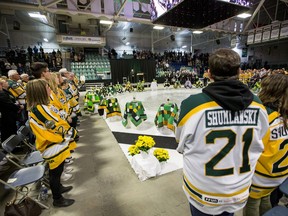 Family members and community members join in a moment of silence during the Humboldt Broncos memorial service at Elgar Petersen Arena in Humboldt, Saskatchewan on Saturday, April, 6, 2019. One year ago today, sixteen people were killed and 13 were injured after the Saskatchewan hockey team's bus collided with a semi driven by a novice trucker who had blown the stop sign at a rural intersection.THE CANADIAN PRESS/POOL-Liam Richards