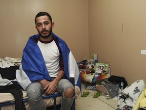 In this March 23, 2019 photo, Nicaraguan exile Carlos Andres Monterrey poses for a photo in his home in San Jose, Costa Rica. Monterrey says he still can't forget the 20 hours he spent under fire by Nicaraguan government paramilitaries.