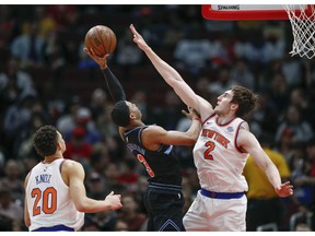 Chicago Bulls guard Shaquille Harrison (3) shoots against New York Knicks forward Luke Kornet (2) during the first half of an NBA basketball game Tuesday, April 9, 2019, in Chicago.