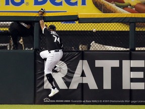 Chicago White Sox left fielder Eloy Jimenez is unable to catch a home run hit by Detroit Tigers' Grayson Greiner during the third inning of a baseball game Friday, April 26, 2019, in Chicago.