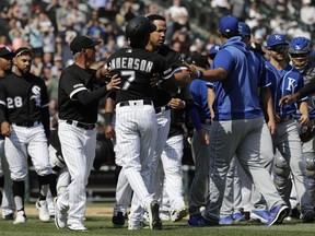 Chicago White Sox's Tim Anderson (7) is restrained by Jose Abreu after he was hit by a pitch from the Kansas City Royals, as benches cleared during the sixth inning of a baseball game in Chicago, Wednesday, April 17, 2019. The Royals won 4-3 in 10 innings.