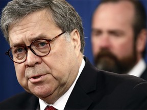 Attorney General William Barr speaks alongside Deputy Attorney General Rod Rosenstein about the release of a redacted version of special counsel Robert Mueller's report during a news conference, Thursday, April 18, 2019, at the Department of Justice in Washington.