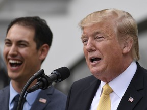 President Donald Trump, right, speaks as he welcomes Joey Logano, left, the 2018 NASCAR Cup Series Champion, to the South Lawn of the White House in Washington, Tuesday, April 30, 2019.