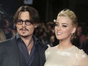 In this Nov. 3, 2011 file photo, U.S. actors Johnny Depp, left, and Amber Heard arrive for the European premiere of their film, "The Rum Diary," in London.