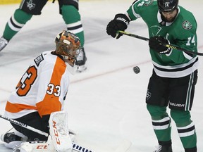 Philadelphia Flyers goaltender Cam Talbot (33) defends the goal against Dallas Stars left wing Jamie Benn (14) during the first period of an NHL hockey game in Dallas, Tuesday, April 2, 2019.