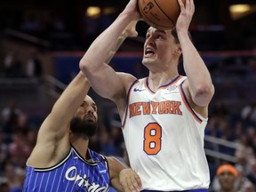 New York Knicks' Mario Hezonja (8) goes up for a shot against Orlando Magic's Evan Fournier (10) during the first half of an NBA basketball game Wednesday, April 3, 2019, in Orlando, Fla.