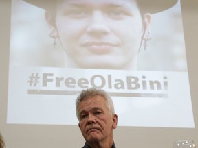 The father of detained Swedish programmer Ola Bini, Dag Gustafsson, attends a press conference in Quito, Ecuador, Tuesday, April 16, 2019. The ace Swedish programmer, pictured on the screen in the background, who was an early, ardent supporter of WikiLeaks was arrested in Ecuador last week in an alleged plot to blackmail the country's president over his abandonment of Julian Assange.