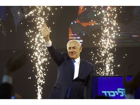 Israel's Prime Minister Benjamin Netanyahu waves to his supporters after polls for Israel's general elections closed in Tel Aviv, Israel, Wednesday, April 10, 2019.