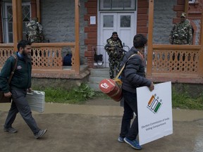 Kashmiri polling officials carry electronic voting machines and other election material on the eve of the second phase of India's general election outside a distribution center in Srinagar, Indian controlled Kashmir, Wednesday, April 17, 2019. With 900 million of India's 1.3 billion people registered to vote, the Indian national election is the world's largest democratic exercise.