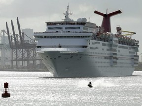 In this June 20, 2016, file photo, a jet skier passes in front of the Carnival Sensation cruise ship as it leaves PortMiami, in Miami Beach, Fla.