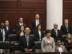 Newly-elected MLAs stand during an orientation at the Alberta Legislature in Edmonton on Wednesday, April 24, 2019.