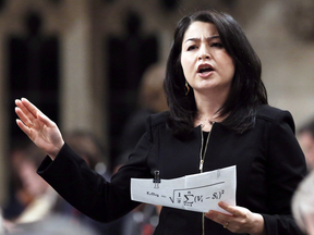 Minister of Democratic Institutions Maryam Monsef holds a piece of paper displaying the Gallagher Index in the House of Commons, Dec. 1, 2016.