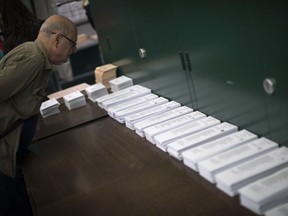 A man inspects the ballot papers at a polling station before voting for the general election in Barcelona.