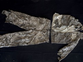 In this Thursday, March 26, 2019 photo, the clothes of a victim with monogram 'MG" embroidered into the shirt, photographed after the body was exhumed from a mass grave at the cemetery of Paterna, near Valencia, Spain, after archaeologists in Spain unearthed layers of human bones last year.  DNA tests will be conducted  in the hope of confirming the identities of those who disappeared eight decades ago, believed to be executed by the forces of Gen. Francisco Franco during and after the 1936-39 Spanish Civil War.