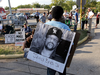 A man wears a photograph of James Byrd Jr. outside the Texas Department of Criminal Justice Huntsville Unit before the execution of Lawrence Russell Brewer in Huntsville, Texas, Sept. 21, 2011.