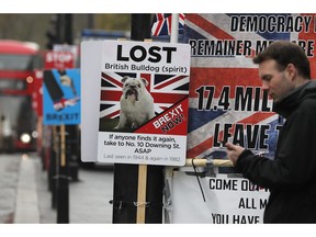 Posters of protestors opposite the Houses of Parliament in London, Monday, April 8, 2019. Britain's Prime Minister Theresa May will hold talks with the leaders of Germany and France ahead of a key Brexit summit later this week.