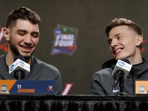 Virginia's Ty Jerome, left, and Kyle Guy laugh as they answer questions during a news conference for the championship of the Final Four NCAA college basketball tournament, Sunday, April 7, 2019, in Minneapolis. Virginia will play Texas Tech on Monday for the national championship.