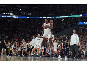 Virginia players celebrate after defeating Auburn 63-62 in the semifinals of the Final Four NCAA college basketball tournament, Saturday, April 6, 2019, in Minneapolis.